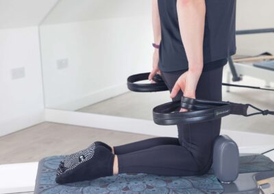 Hands holding reformer straps